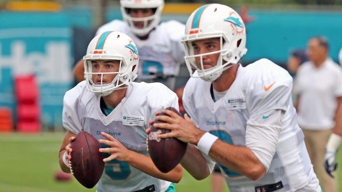 Miami Dolphins quarterbacks David Fales (9) and Brock Osweiler (8) during a drill at training camp 2018.