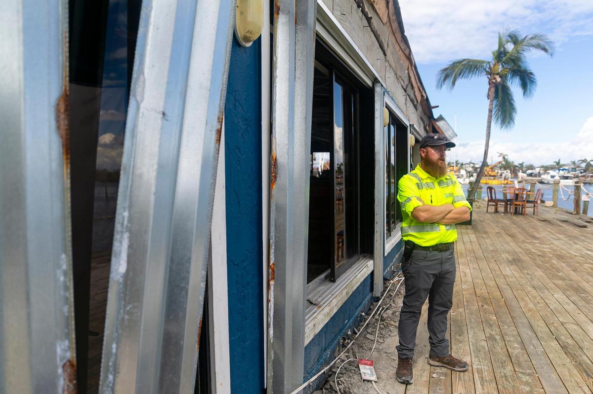 James Fountain, 40, with the U.S. Geological Survey, stands outside of the Nauti Parrot Dock Bar on Tuesday, Oct. 18, 2022, in Fort Myers Beach, Florida.