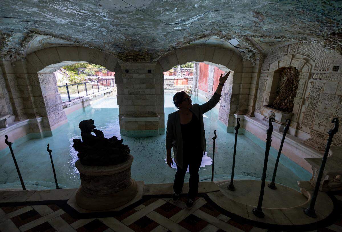 Davina Kuh Jakobi, the lead conservator at Vizcaya Museum and Gardens, points to a detail in Robert Winthrop Chanler’s 107-year-old ceiling mural at the museum’s grotto and swimming pool.