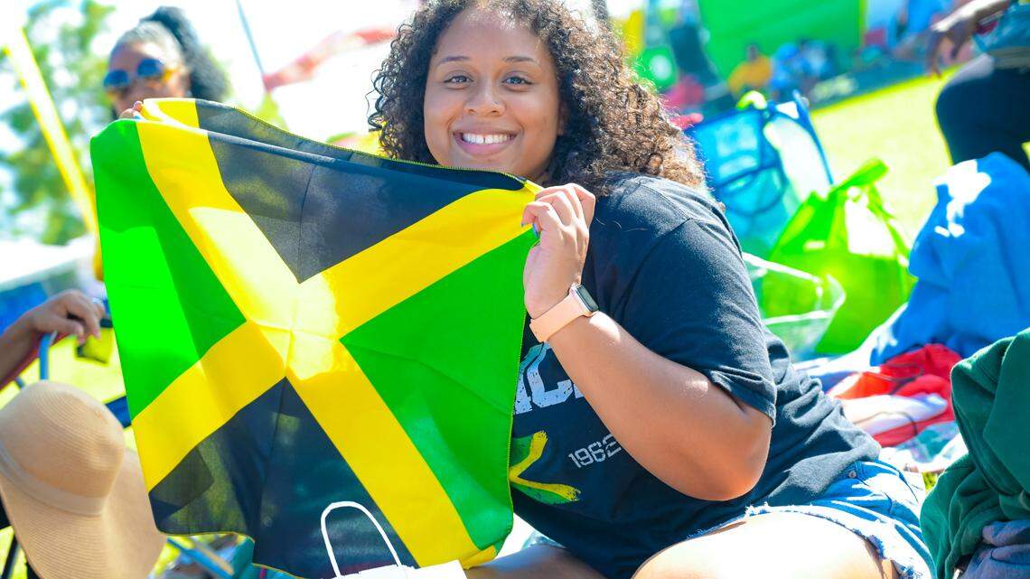 A festivalgoer waves a Jamaican flag at the Grace Jamaican Jerk Festival.