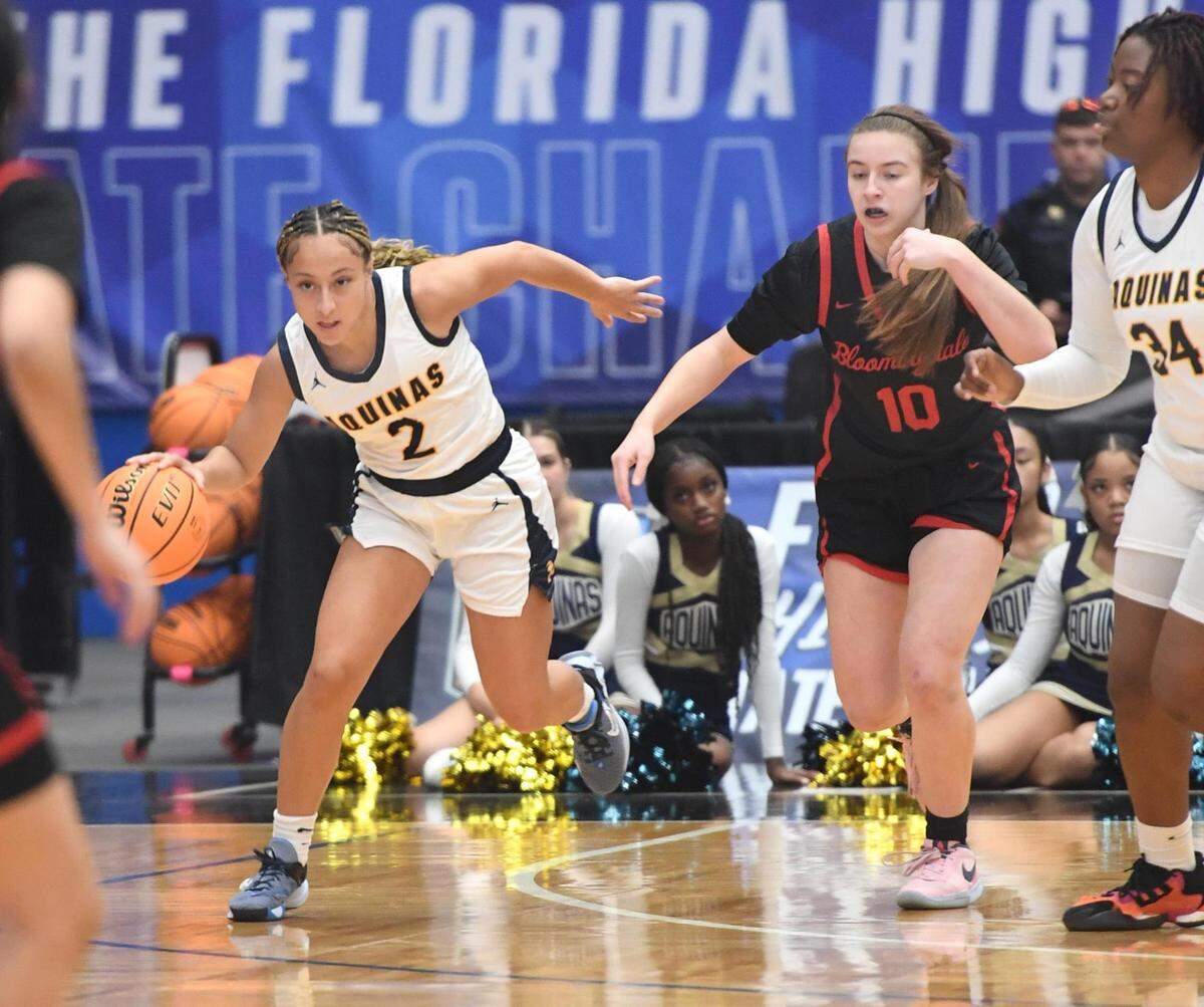 St. Thomas Aquinas’ Jaelyn Cardoza (2) comes up with a loose ball against Bloomingdale’s Noelle Mengel (10) in the Class 6A final during the Florida High School State Championships at the RP Funding Center in Lakeland, Fl on Friday March 8, 2024. St. Thomas defeated Bloomingdale 70-35. Scott Wheeler | Photo