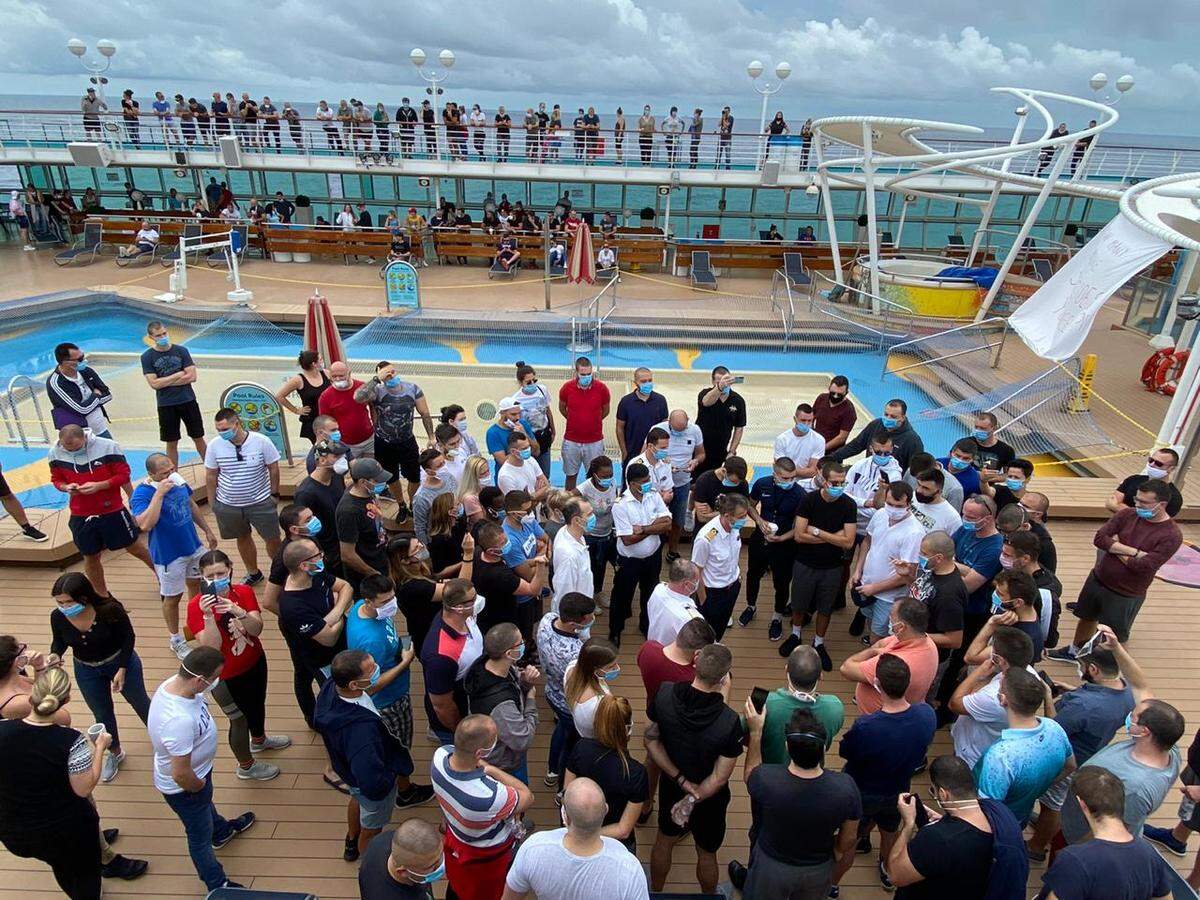Crew members on Royal Caribbean’s Majesty of the Seas cruise ship demand answers from the captain about when they will be going home on May 15, 2020.