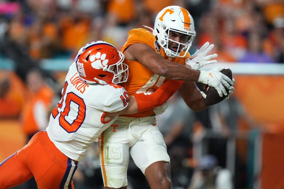 Dec 30, 2022; Miami Gardens, FL, USA; Tennessee Volunteers wide receiver Bru McCoy (15) scores a touchdown past Clemson Tigers cornerback Jeadyn Lukus (10) during the first half of the 2022 Orange Bowl at Hard Rock Stadium.