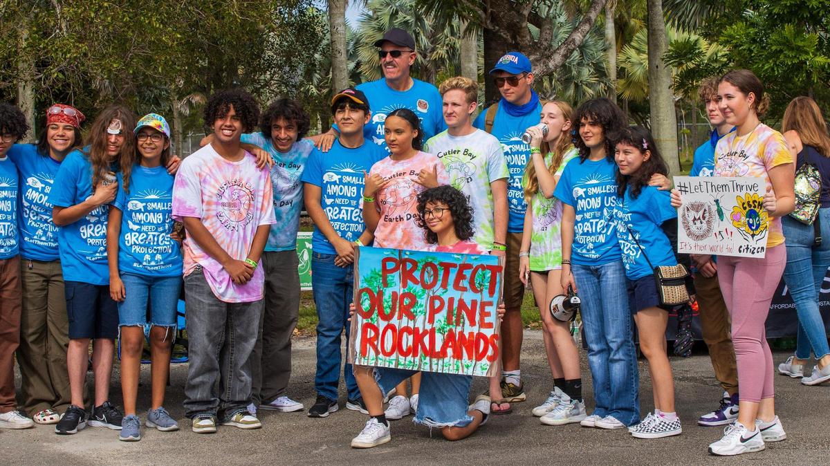 Ron Magill (center), of Zoo Miami ,leads a group of South Florida residents during a rally to convince the Miami-Dade commission to vote against a controversial plan to build the Miami Wilds water park next to Zoo Miami, on Nov. 4, 2023.
