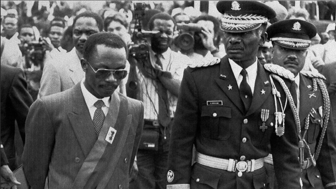 President Jean-Bertrand Aristide walks with Haitian Armed Forces Chief of Staff General Hérard Abraham while inspecting the troops at the Presidential Palace after his inauguration ceremony in Port-au-Prince, Feb. 8, 1991.