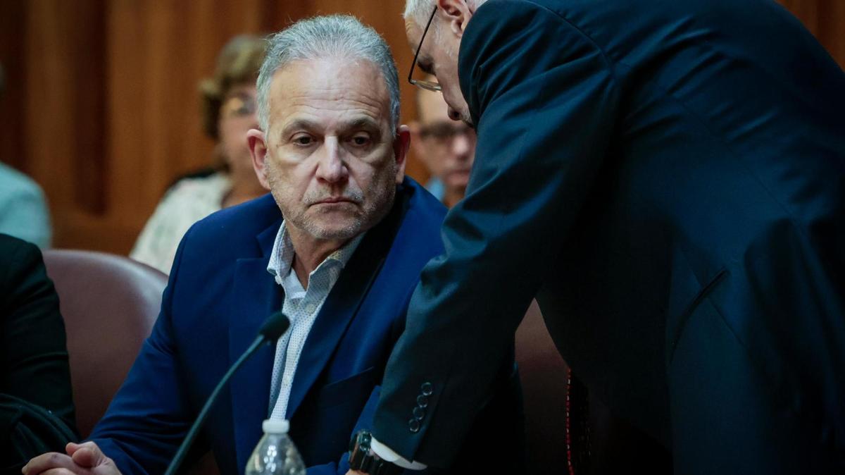 Lawyer Jose Quiñon, right, confers with his client, Manuel Marin, on Wednesday. Marin, who once owned Presidente Supermarket stores, is accused in a murder-for-hire plot of his wife’s lover at the time.