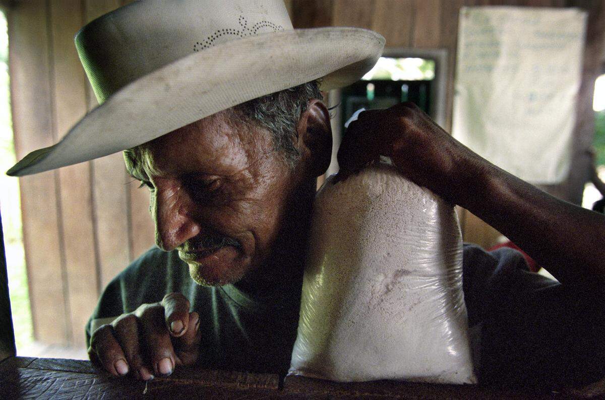 A farmer waits for his turn to sell his weekly coca paste at an open market in the town of Peñas Coloradas, Colombia.Farmers in the region rely on coca production to live, since other products are hard to transport and sell in city markets.