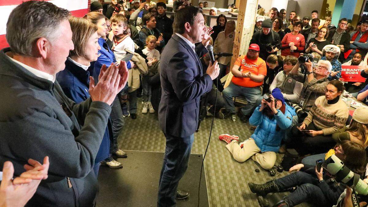 From left: Evangelical Leader Bob Vander Plaats, left, Iowa Governor Kim Reynolds, and Casey DeSantis, holding son Mason DeSantis, watch as Florida Gov. Ron DeSantis speaks during a rally on Saturday, Jan 13, 2023, at the Never Back Down super PAC headquarters in West Des Moines, IA.