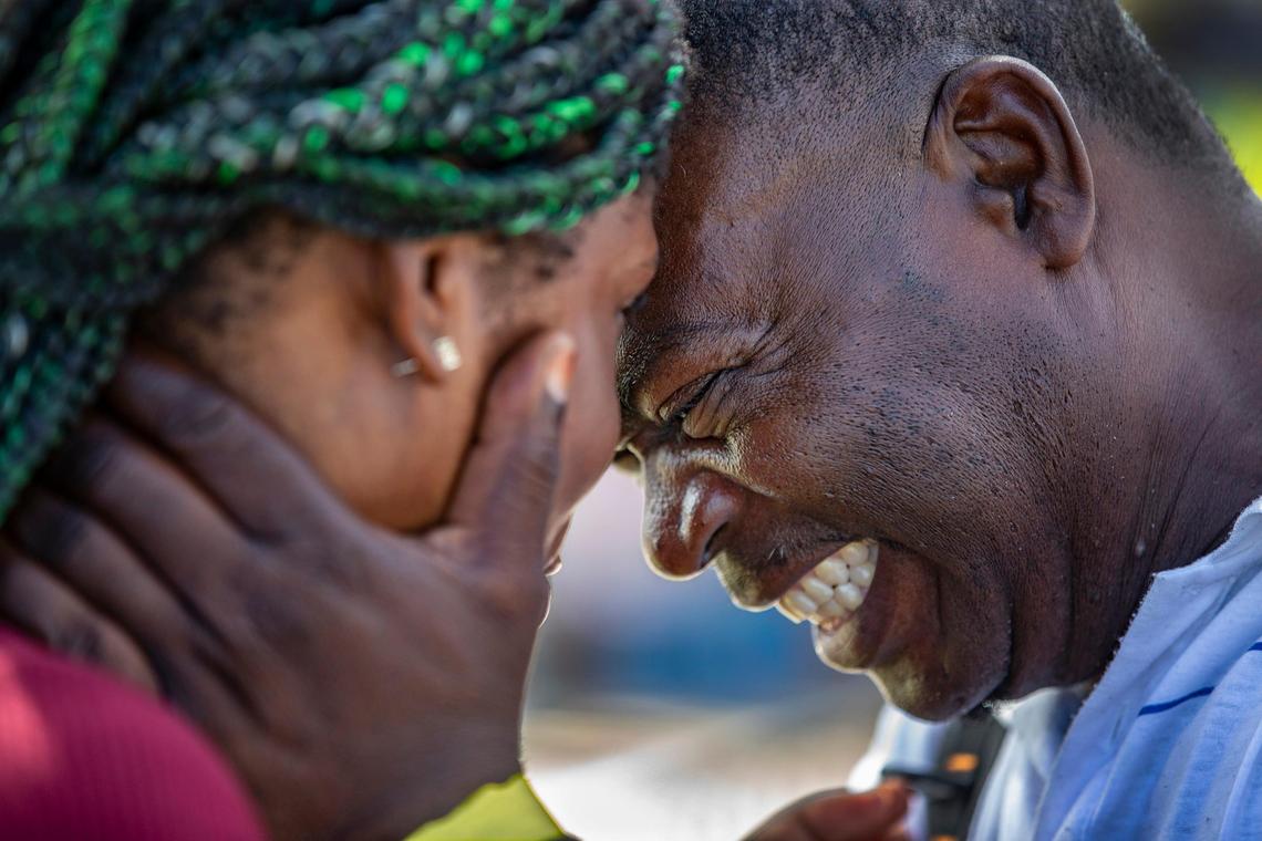 Bernard Monestime and his wife, Ordena Lauroe, embrace as they wait to be checked into a shelter for Hurricane Dorian victims in Nassau, Bahamas, on Monday, Sept. 9, 2019.