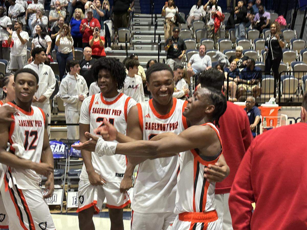 Sagemont boys’ basketball players celebrate on the court following their 67-63 victory over Lakeland Victory Christian on Saturday at UNF Arena in Jacksonville, Fla.