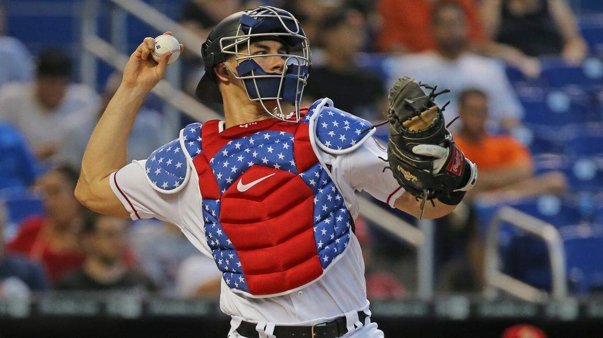 Miami Marlins catcher J.T. Realmuto throws while wearing a patriotic chest protector during the third inning against the Tampa Bay Rays at Marlins Park in Miami on Tuesday, July 3, 2018.