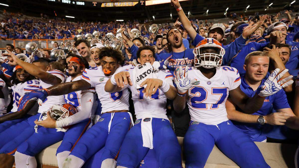 Trevon Grimes #8 of the Florida Gators, Feleipe Franks #13 of the Florida Gators, and Dameon Pierce #27 of the Florida Gators celebrates the win with the fans after the game between the Florida Gators and Tennessee Volunteers at Neyland Stadium on September 22, 2018 in Knoxville, Tennessee. Florida won the game 47-21.