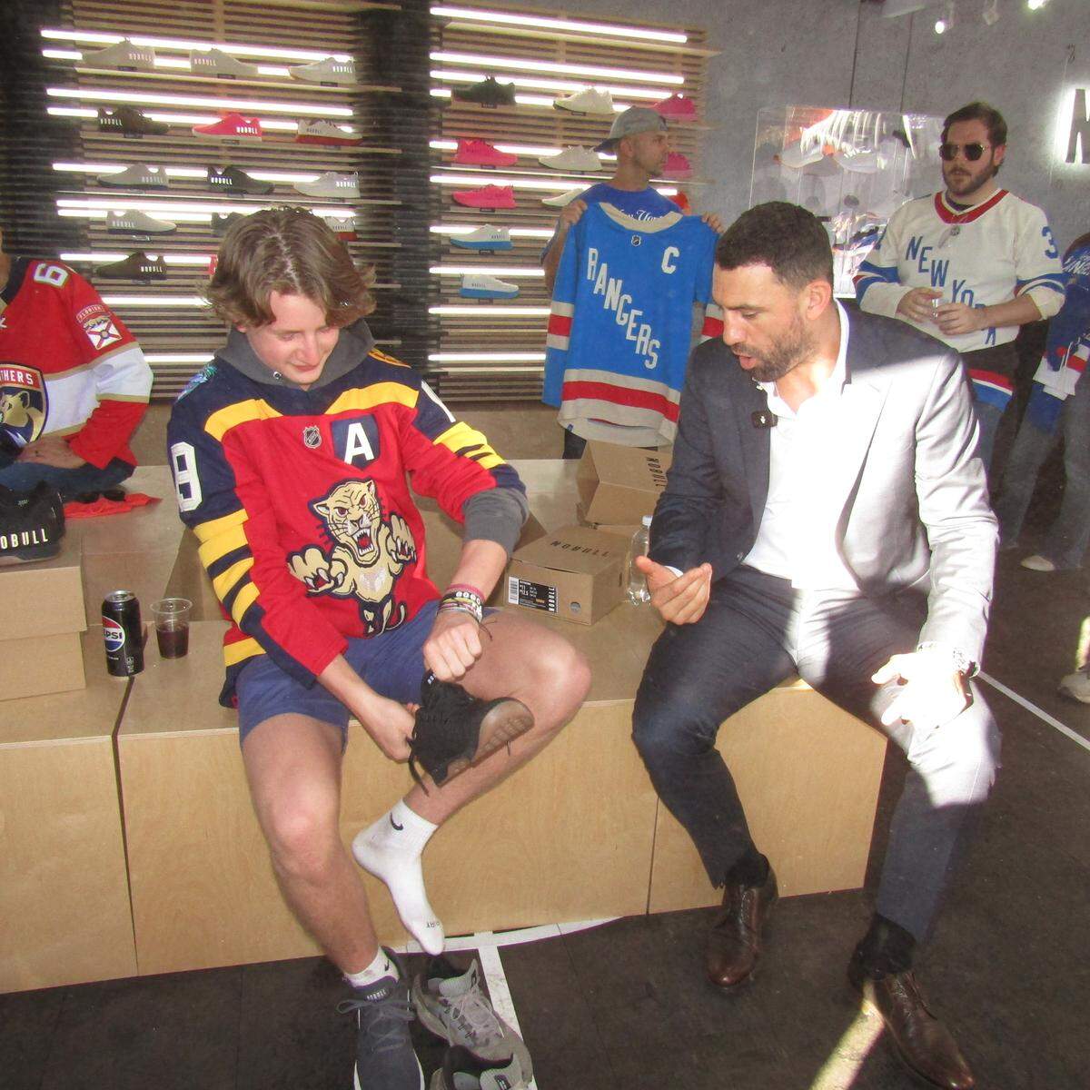 NHL alum Paul Bissonnette of the “NHL on TNT” broadcast team gives a fan a free pair of sneakers, courtesy of NOBULL during the Enterprise NHL Winter Classic Pregame Fanfest outside loanDepot Park.