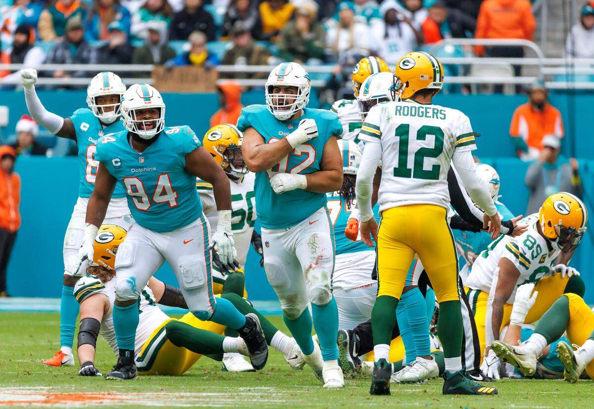 Miami Dolphins defensive tackle Zach Sieler (92) celebrates with teammate Christian Wilkins (94) after a play during second quarter of an NFL football game against the Green Bay Packers at Hard Rock Stadium on Sunday, December 25, 2022 in Miami Gardens, Florida.