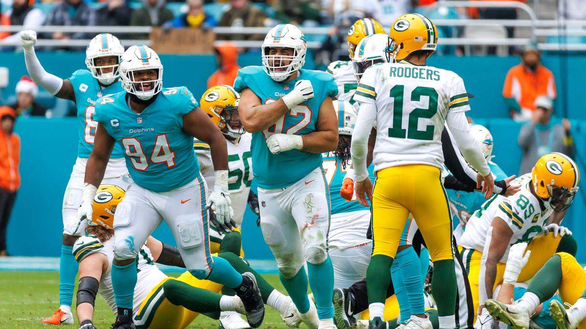 Miami Dolphins defensive tackle Zach Sieler (92) celebrates with teammate Christian Wilkins (94) after a play during second quarter of an NFL football game against the Green Bay Packers at Hard Rock Stadium on Sunday, December 25, 2022 in Miami Gardens, Florida.