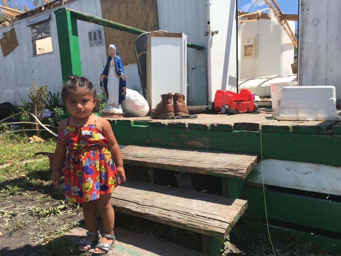 Jocelyn Flores, 21 months, stands outside her family’s home in Immokalee, which was destroyed by winds associated with Hurricane Irma