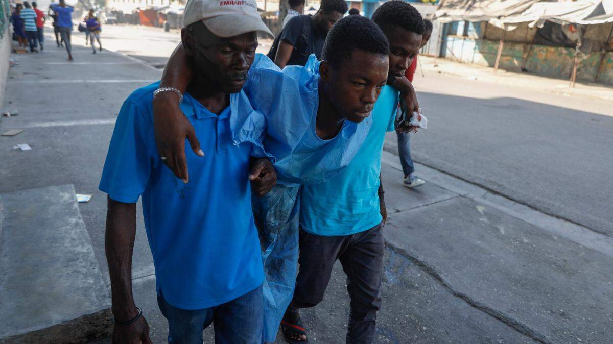 Men help evacuate a man from the General Hospital during gang violence in Port-au-Prince, Haiti, Thursday, Feb. 29, 2024. Gunmen shot at the international airport and other targets in a wave of violence that forced businesses, government agencies and schools to close early. (AP Photo/Odelyn Joseph)