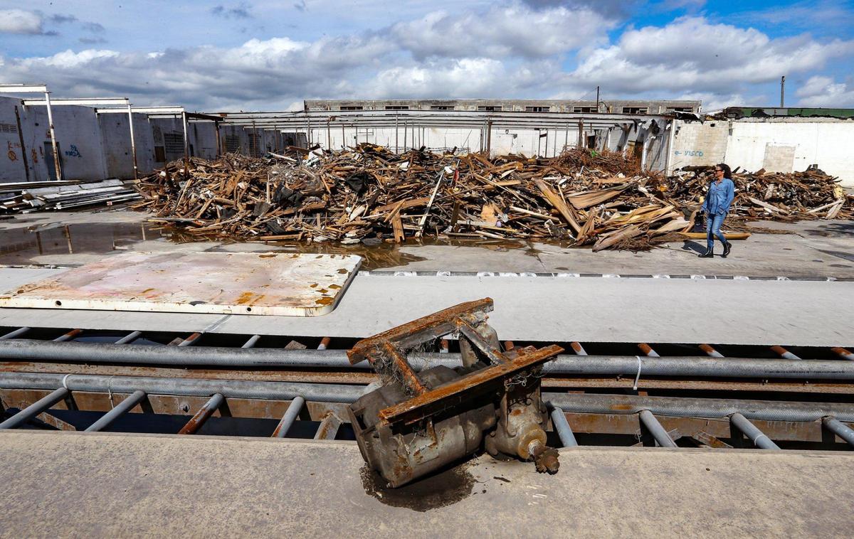 Developer Avra Jain walks across a pile of debris left from the removal of a warehouse roof in Hialeah. The warehouse walls, reinforced with steel buttresses, remain standing to make it into an open-air performance space.