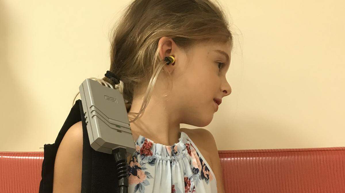 A child is undergoing a diagnostic test known as tympanometry, which checks how well the ear drum is moving. Sometimes negative pressure or fluid in the middle ear will impede the eardrum, causing a hearing loss. Dr. Leah Light, founder of the Brainchild Institute in Hollywood, is conducting the exam.