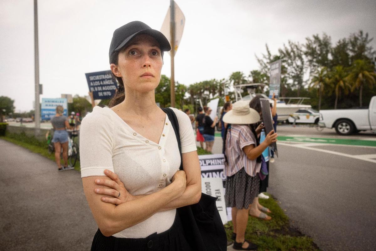 Stephanie Lane, with speciesism.wtf animal rights organization, poses in front of other activists during a gathering organized by SoFlo Animal Rights Activism two days after Lolita’s death outside the Miami Seaquarium on Sunday, Aug. 20, 2023, on Rickenbacker Causeway before Key Biscayne.