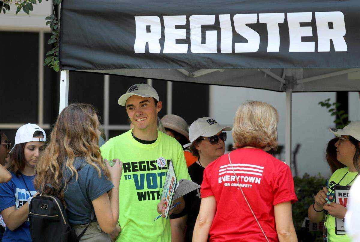 David Hogg, a survivor of the Marjory Stoneman Douglas High School shooting in Parkland, helps register voters in Tallahassee in the summer of 2018. Youth voter registration was energized after the Feb. 14 school shooting.