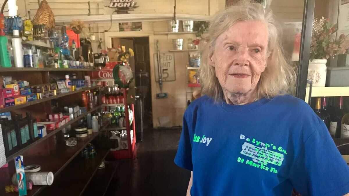 Joy Brown, who declined to give her age other than that she’s “been 39 for a long time,” stands in the grocery store that doubles as her house in the back the day after Hurricane Michael pushed 10 feet of water from the Gulf of Mexico into her place.