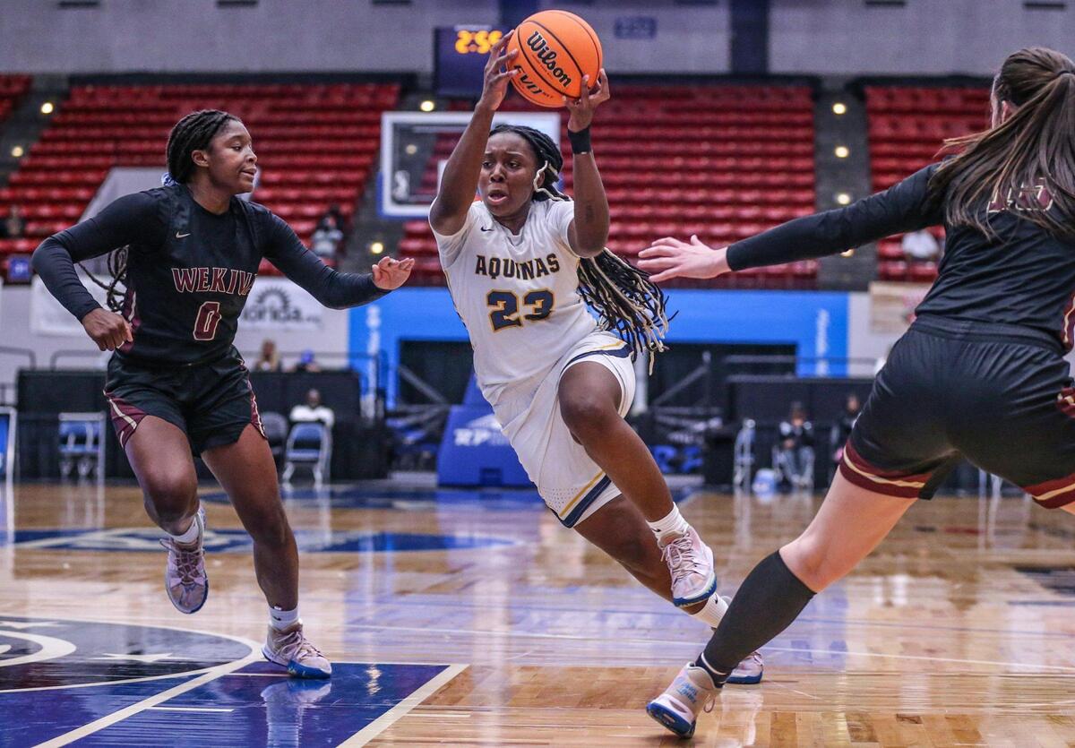Breanna Gustave (23) drives to the basket as Wekiva’s Jade Lewis (0) defends in the Class 6A girls basketball state championship at the RP Funding Center in Lakeland on Saturday, February 26, 2022.