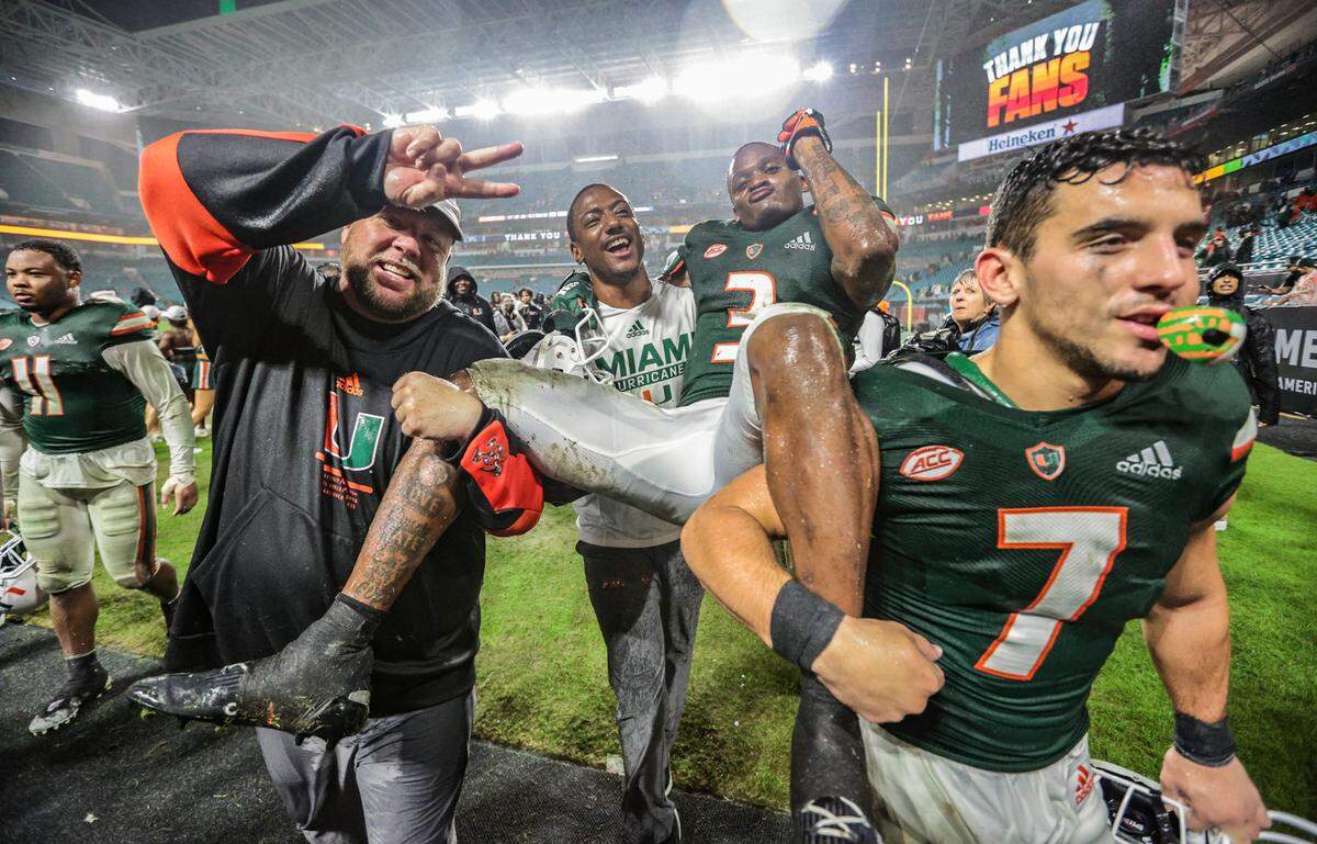 Miami Hurricanes wide receiver Mike Harley (3) is carried off the field by teammates after the Hurricanes defeat Virginia Tech Hokies at Hard Rock Stadium in Miami Gardens on Saturday, November 20, 2021