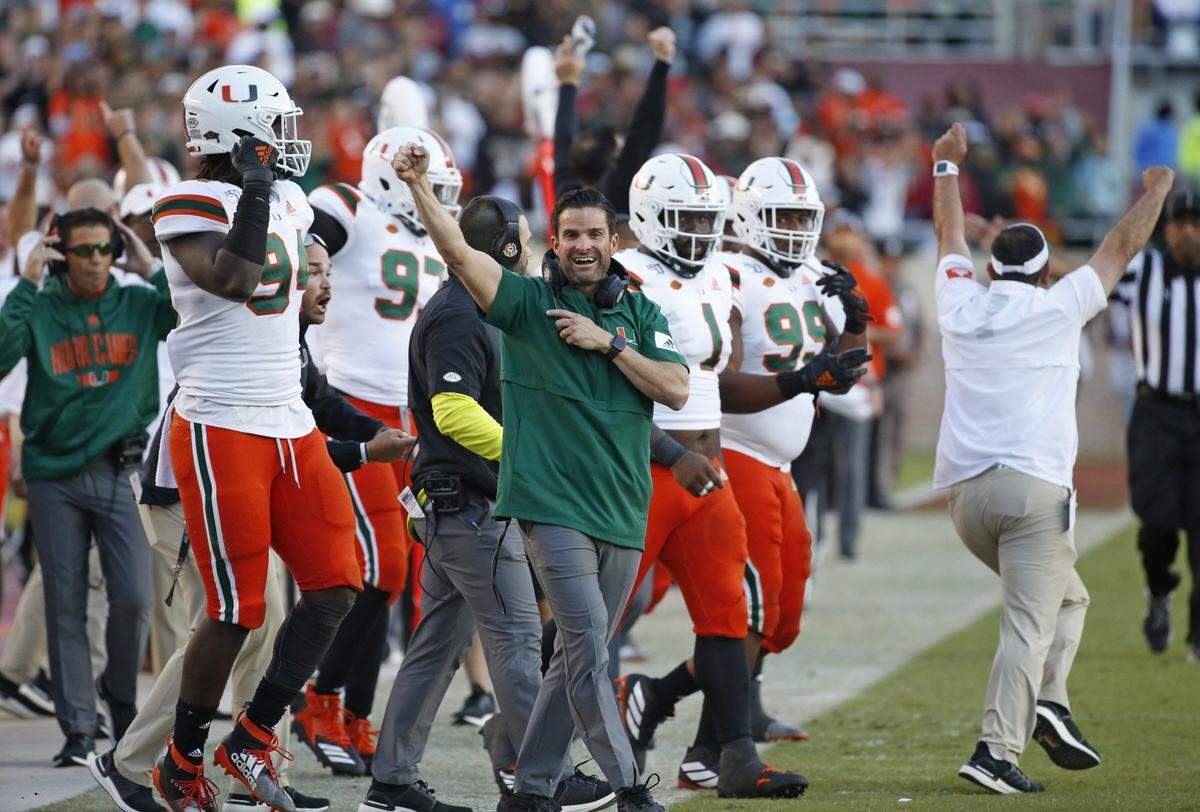 Miami Hurricanes head coach Manny Diaz pumps his fist in the air from the sidelines late in the fourth quarter as the Seminoles host the Miami Hurricanes at Doak Campbell Stadium in Tallahassee on Saturday, November 2, 2019.