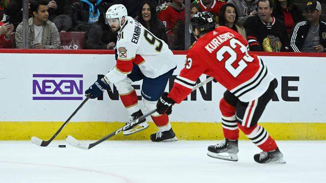 Nov 4, 2023; Chicago, Illinois, USA; Florida Panthers defenseman Oliver Ekman-Larsson (91) moves the puck past Chicago Blackhawks center Philipp Kurashev (23) during the first period at the United Center. Mandatory Credit: Matt Marton-USA TODAY Sports