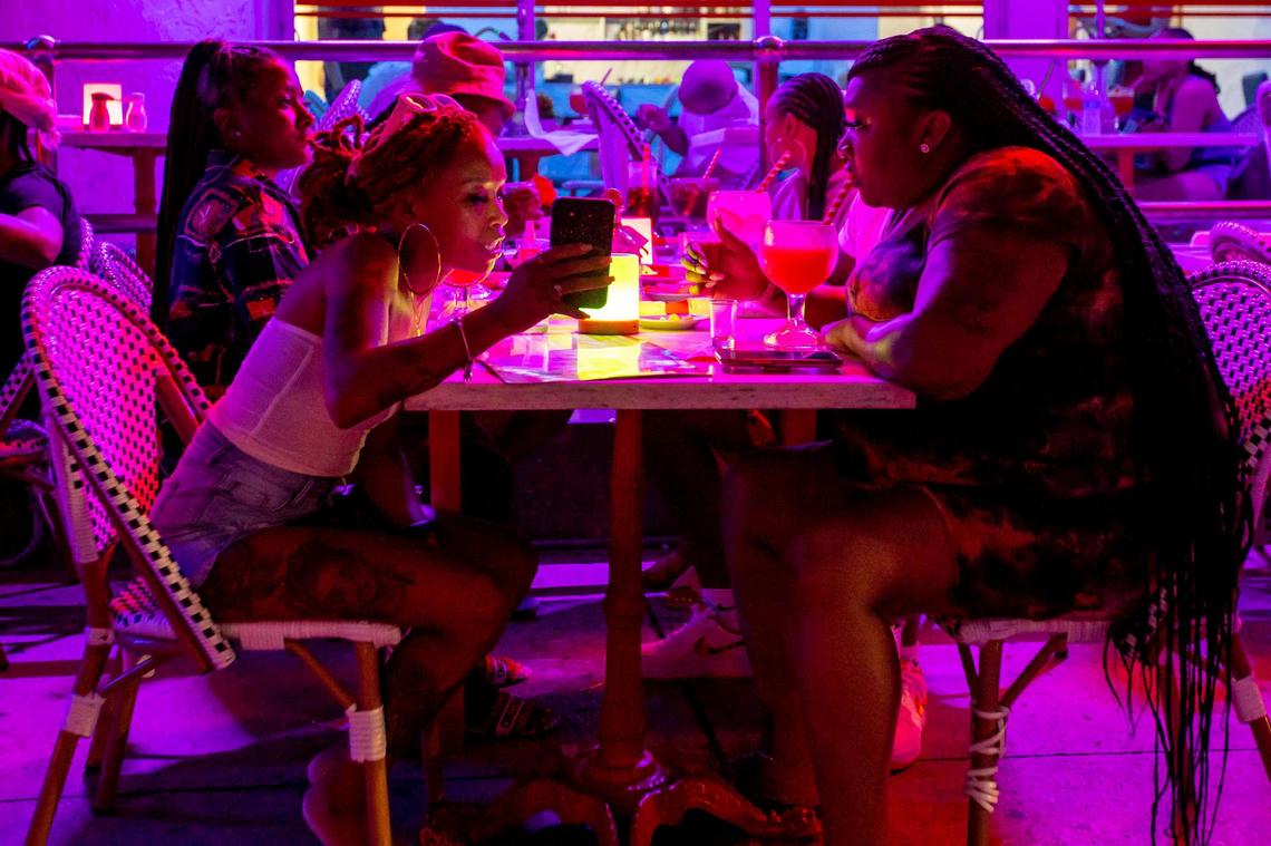 A group eats at a restaurant off Ocean Drive during the second day of Memorial Day Weekend in Miami Beach, Florida, on Saturday, May 28, 2022.