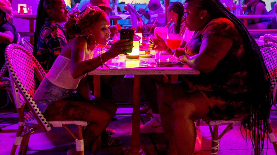 A group eats at a restaurant off Ocean Drive during the second day of Memorial Day Weekend in Miami Beach, Florida, on Saturday, May 28, 2022.
