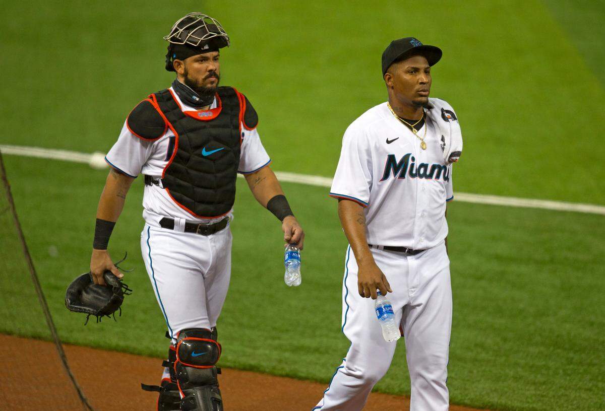 Miami Marlins pitcher Sixto Sanchez (73) and catcher Jorge Alfaro (38) walk into the dugout before the start of a baseball game against the Toronto Blue Jays at at Marlins Park in Miami on Wednesday, September 2, 2020.