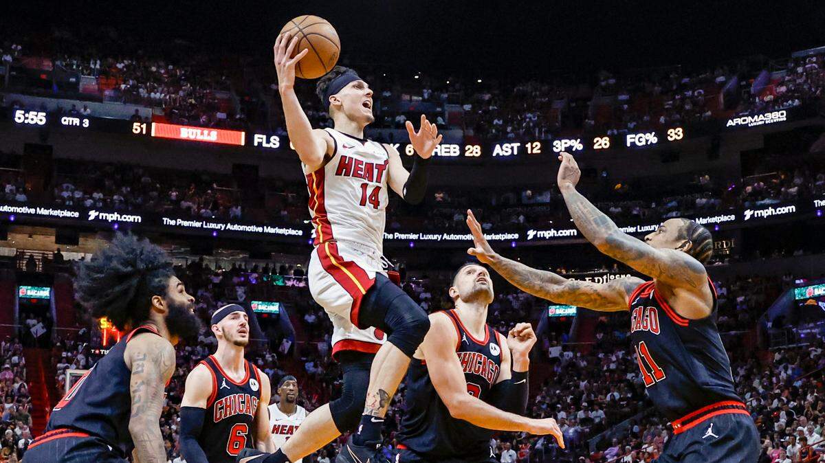 Miami Heat guard Tyler Herro (14) drives to the basket around Chicago Bulls defenders in the third quarter during the 2024 NBA Play-In Tournament at Kaseya Center in Miami, Florida on Friday, April 19, 2024.