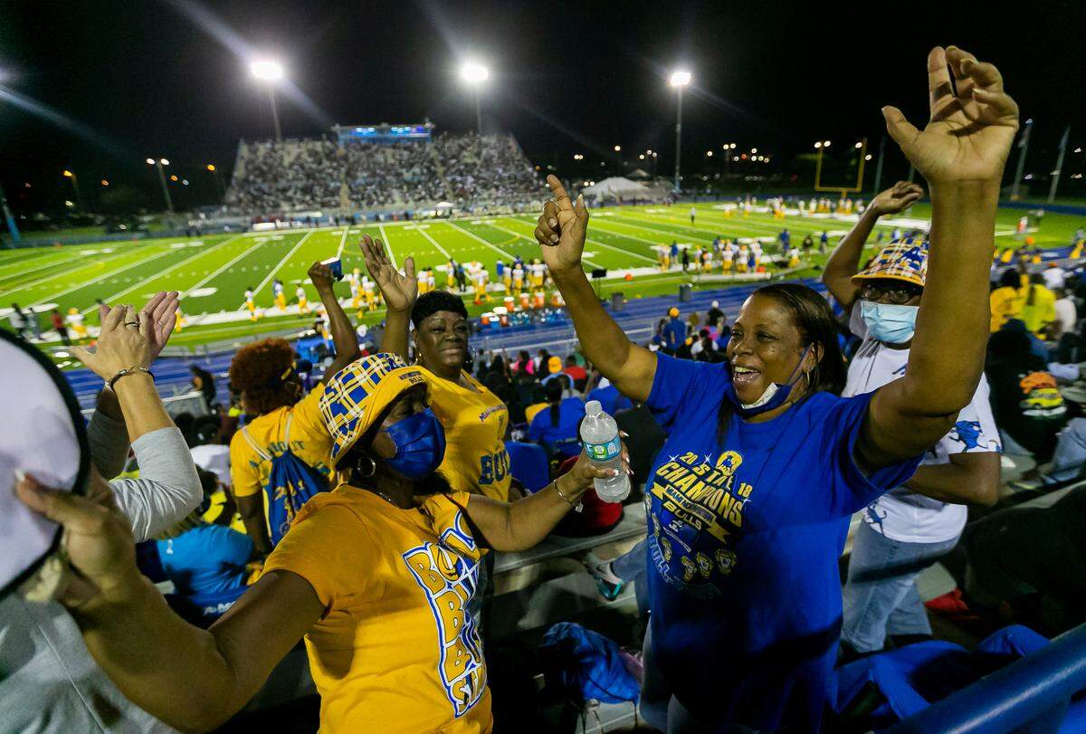 Northwestern Bulls fans cheer after their football team scored against the Miami Central Rockets on Friday, October 1, 2021 at Nathaniel Traz Powell Stadium in Miami, Florida.