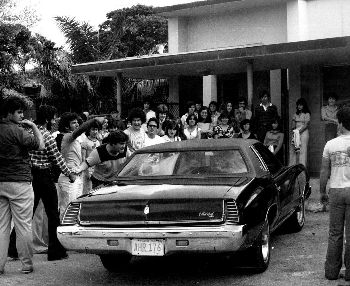 Coral Gables High students gather around a car at school in 1977.