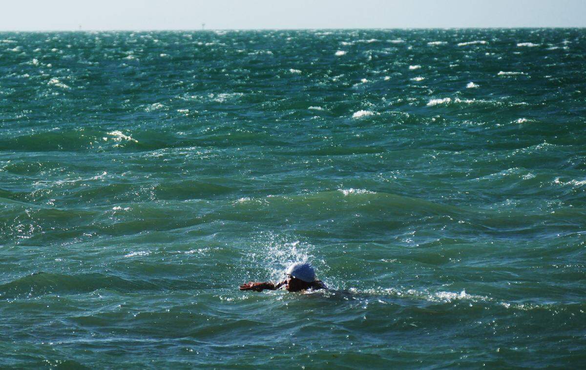 A swimmer struggles against rough seas and strong wind gusts on Virginia Key Friday morning, December 21, 2018. The weather was part of a cold front that pushed through late Thursday and into Friday.