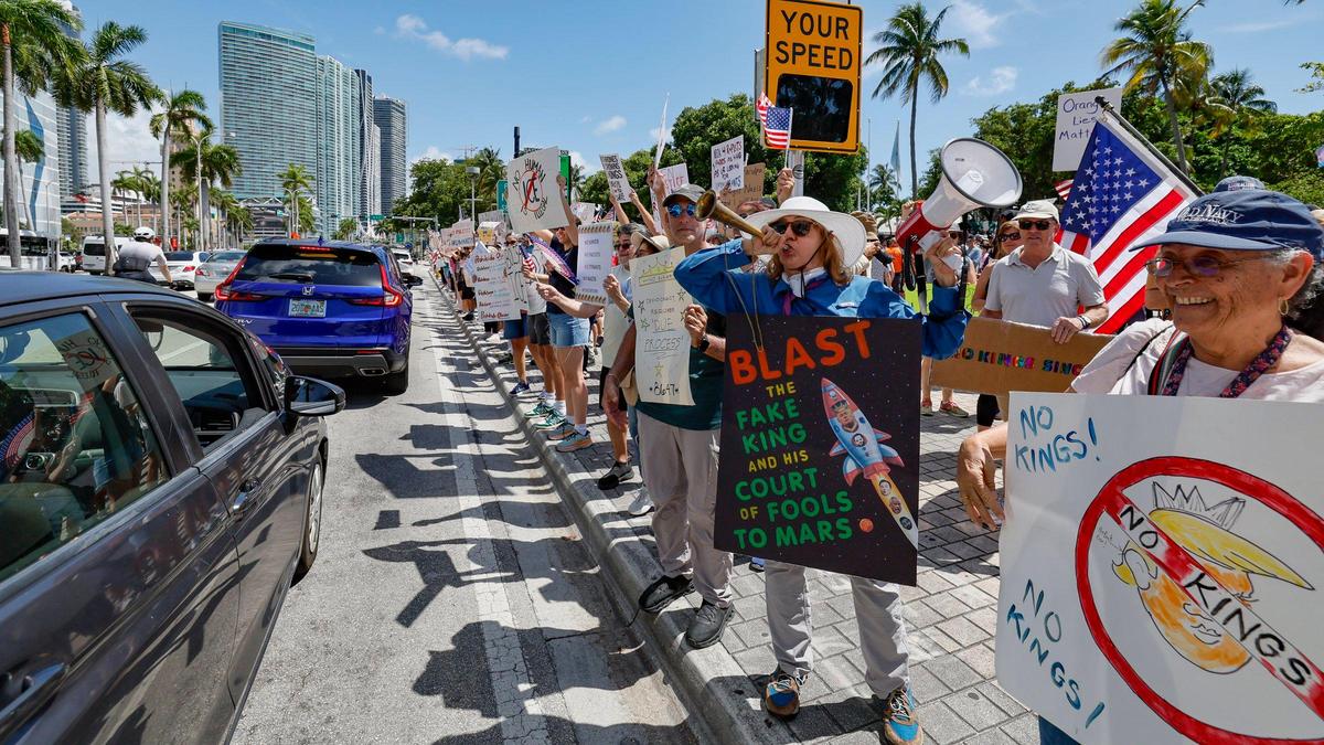 Protesters holler as cars honk in support during a ‘No Kings’ anti-Trump protest at the Torch of Friendship monument at Bayfront Park in Miami, Florida on Saturday, June 14, 2025