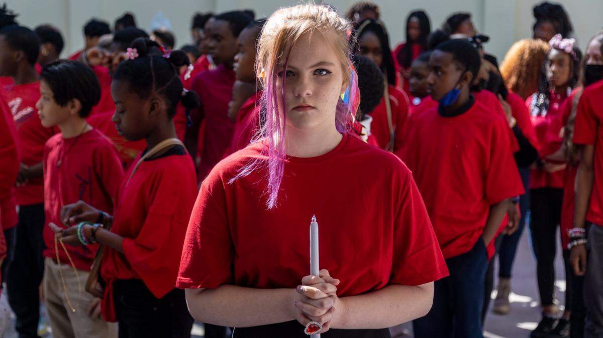 Eighth-grade student Alex Hibbard holds a candle representing one of the victims of the shooting at Marjory Stoneman Douglas as other students stand during a small ceremony at Silver Lakes Middle School in North Lauderdale on Tuesday, Feb. 14.