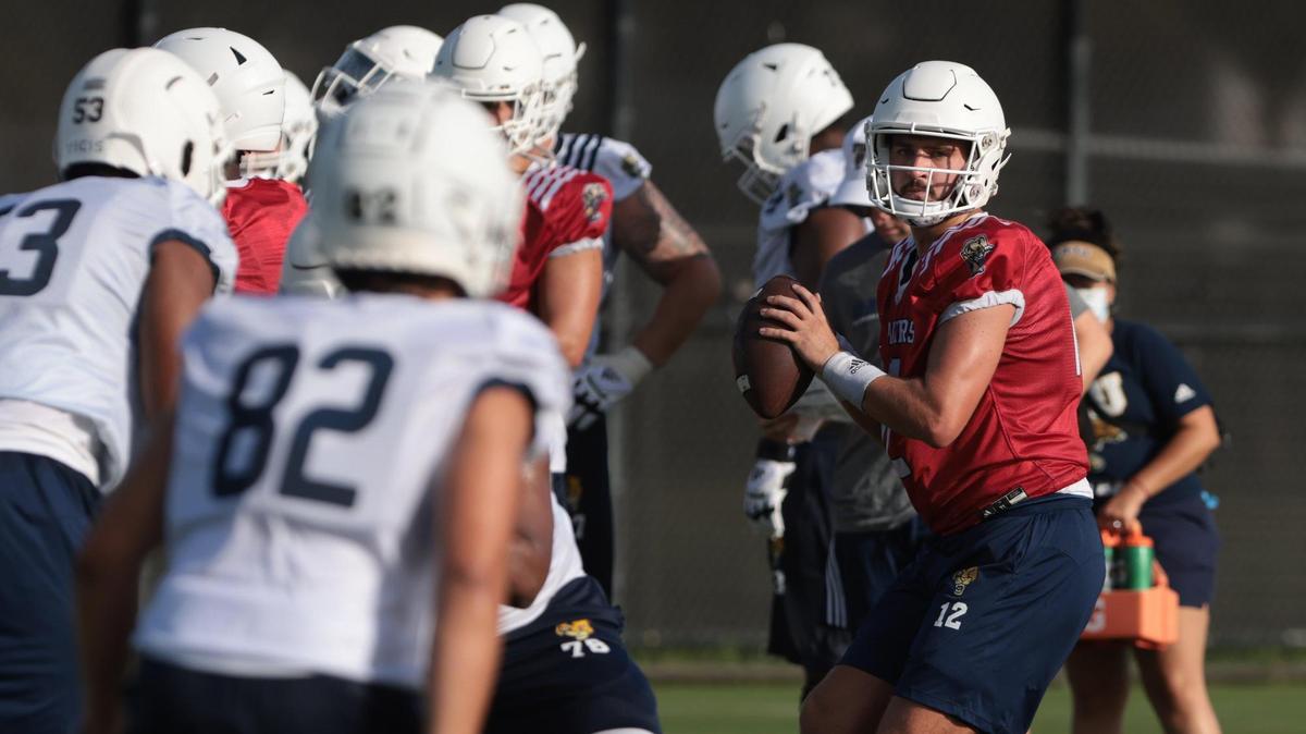 Quarterback Gunnar Holmberg, right, takes the snap and looks cross field during passing drills at practice. On Monday, August 1, 2022 FIU football team opened morning practiced to the media on the practice field on the Tamiami Campus.