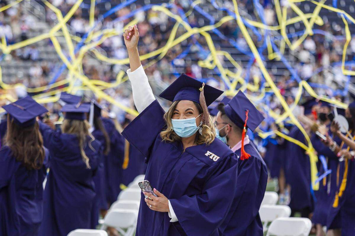 Julianny Guzman, 30, celebrates after graduating from Florida International University at the Riccardo Silva Stadium in Miami, Florida, on Saturday, April 24, 2021.