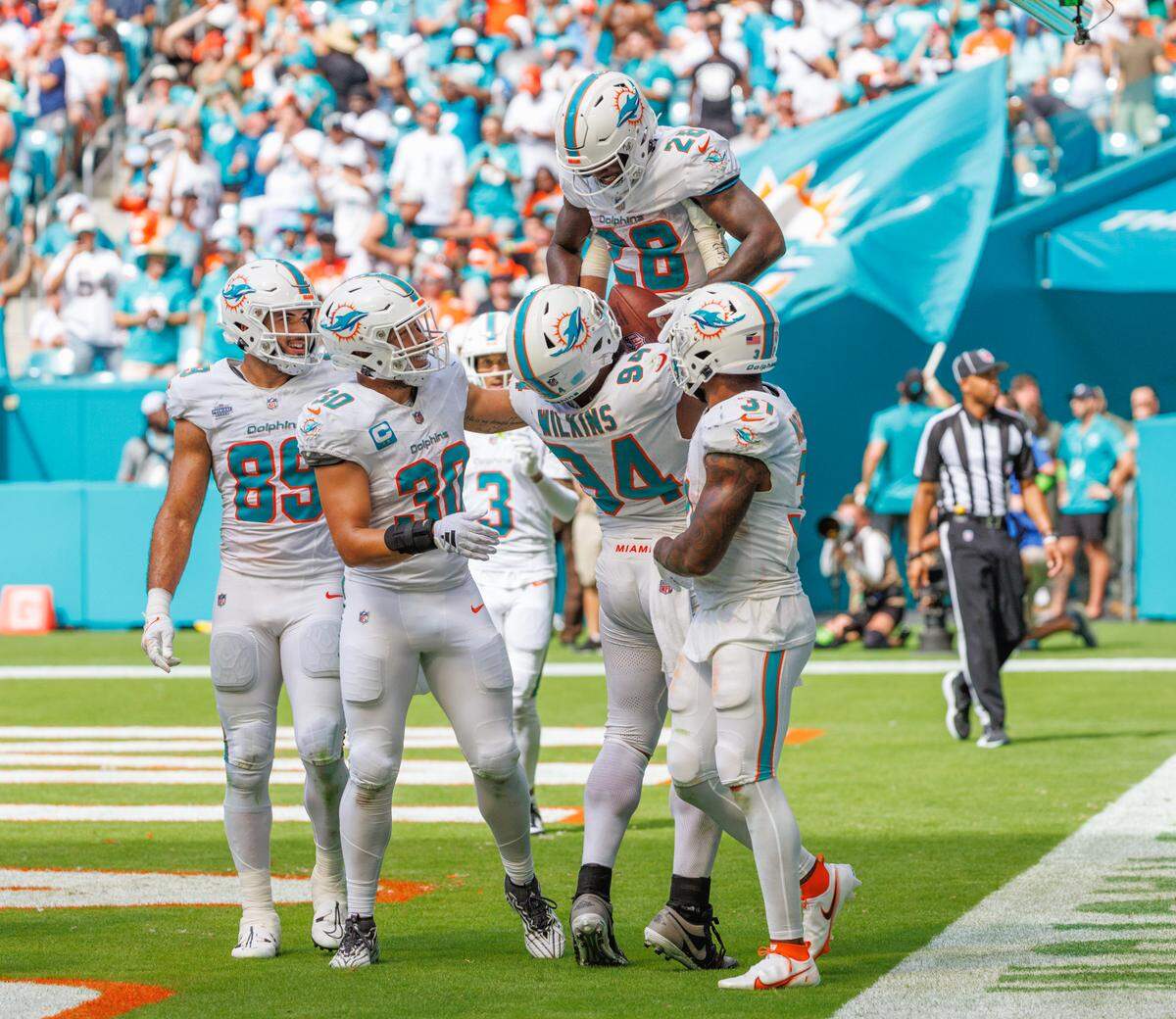 Miami Dolphins running back De’Von Achane (28) celebrates with teammates after scoring a touchdown against the Denver Broncos during fourth quarter of an NFL football game at Hard Rock Stadium on Sunday, Sept. 24, 2023 in Miami Gardens, Fl.