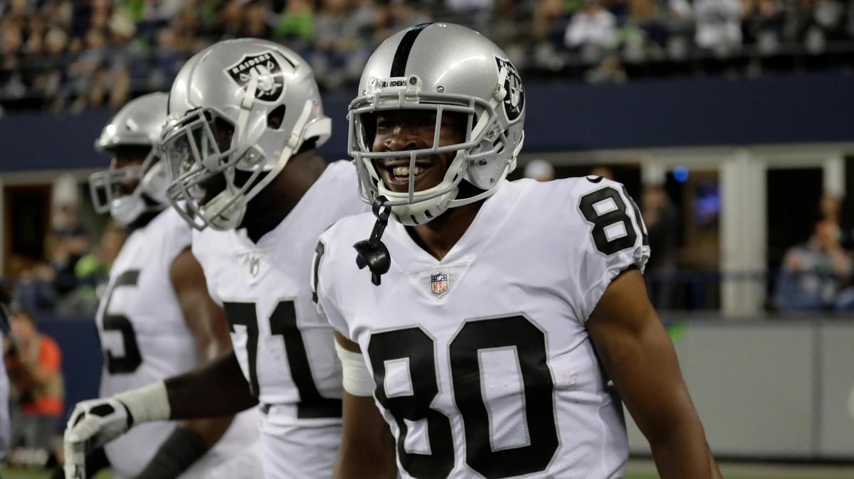 Oakland Raiders wide receiver Saeed Blacknall (80) smiles after he scored a touchdown during the second half of an NFL football preseason game against the Seattle Seahawks, Thursday, Aug. 30, 2018, in Seattle. (AP Photo/Stephen Brashear)