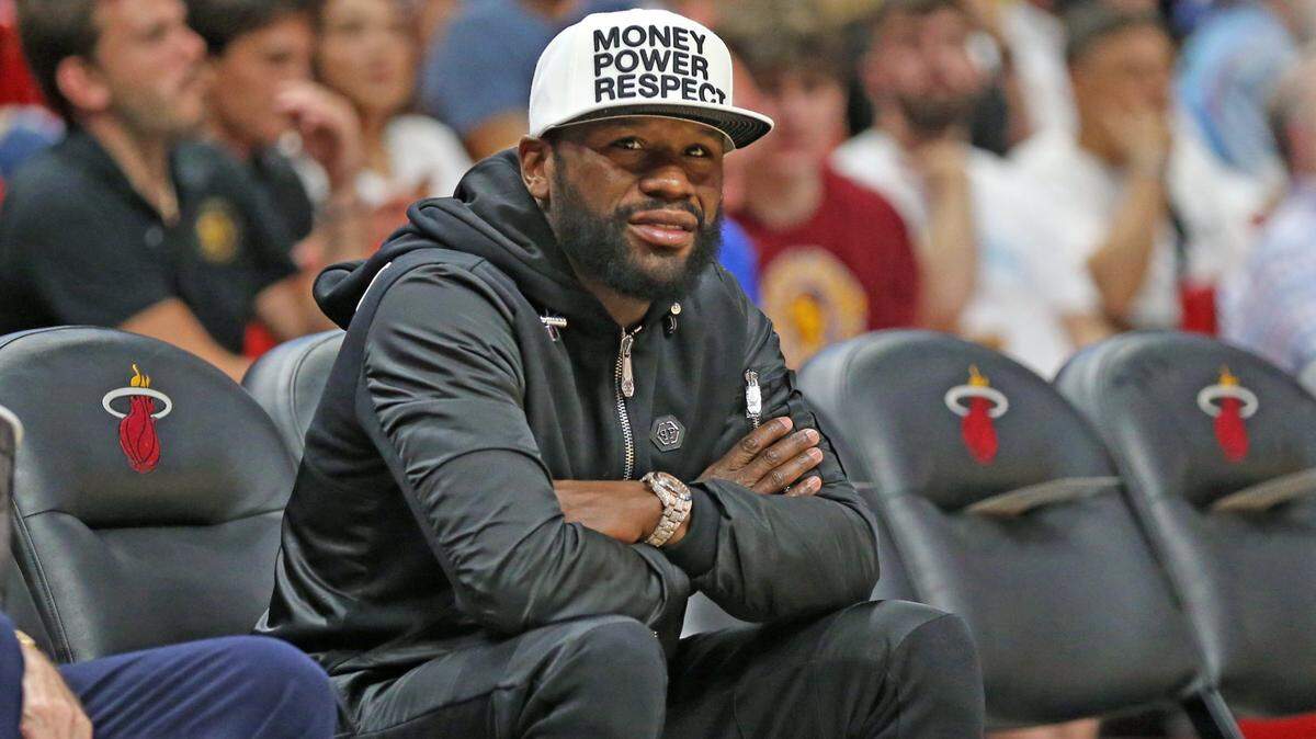 Boxing legend Floyd Mayweather Jr. watches the game between the Miami Heat and the Cleveland Cavaliers at the FTX Arena in Miami on Friday, March 11, 2022.