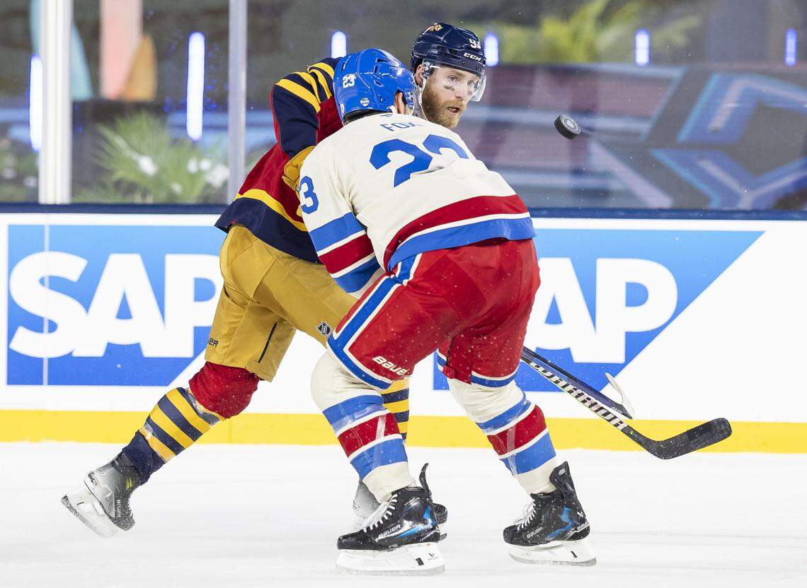 Florida Panthers center Sam Bennett (9) shoots the puck as New York Rangers defenseman Adam Fox (23) defends in the first period of their Winter Classic outdoor hockey game at loanDepot park on Friday, Jan. 2, 2026, in Miami, Fla.