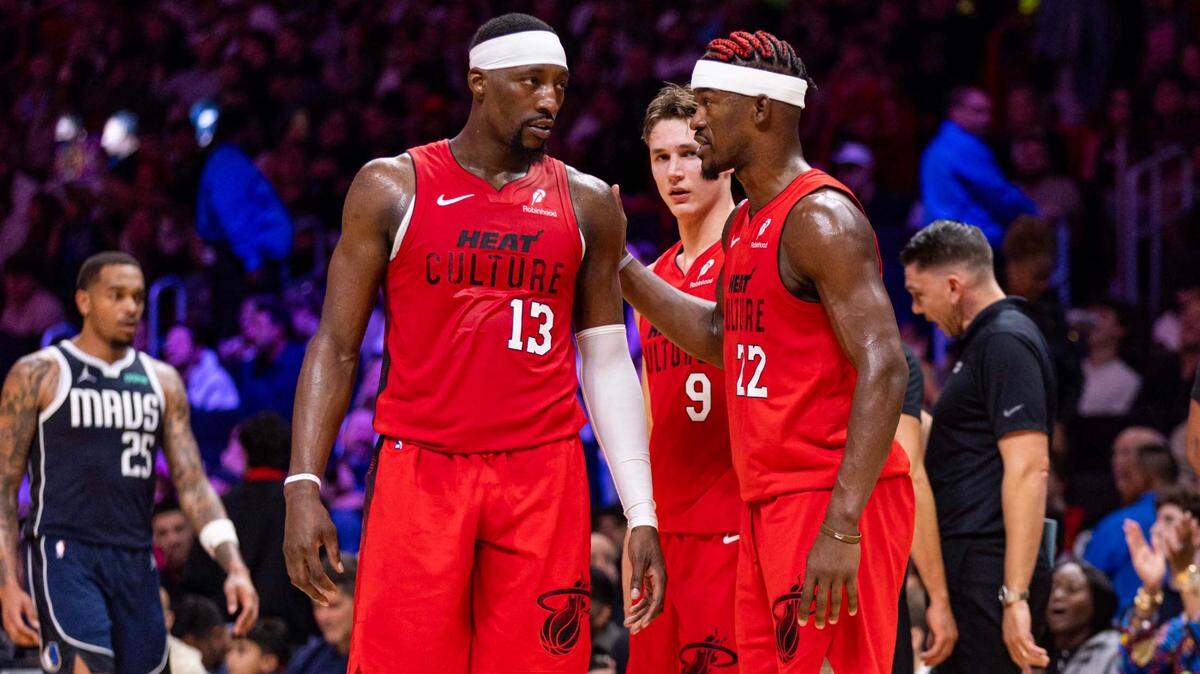 Miami Heat forward Jimmy Butler (22) speaks with teammate Bam Adebayo (13) during the second half of an NBA game against the Dallas Mavericks at Kaseya Center on Nov. 24, 2024, in Miami.
