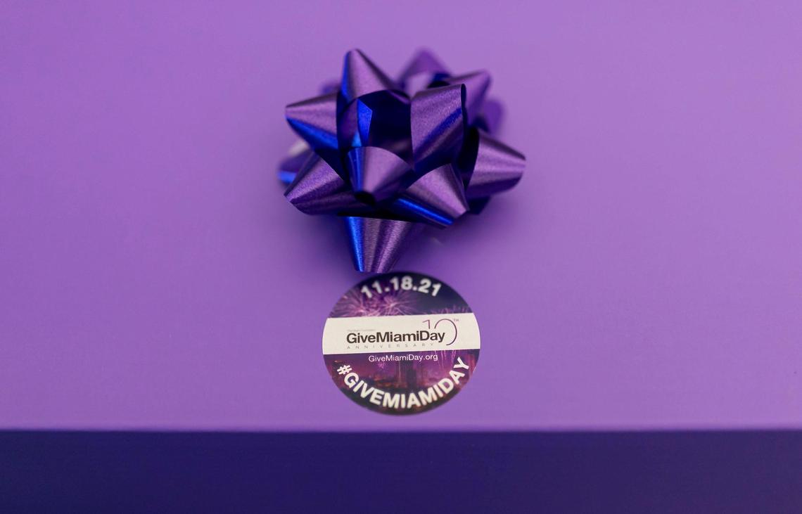 Miami Foundation employees prepared Give Miami Day goody boxes at their offices in downtown Miami, Florida on Wednesday, Nov. 10, 2021. The boxes, which included items like coffee, stickers, sunglasses, beaded necklaces, fans, candy, and more, are to remind their friends, business and local leaders about Give Miami Day.