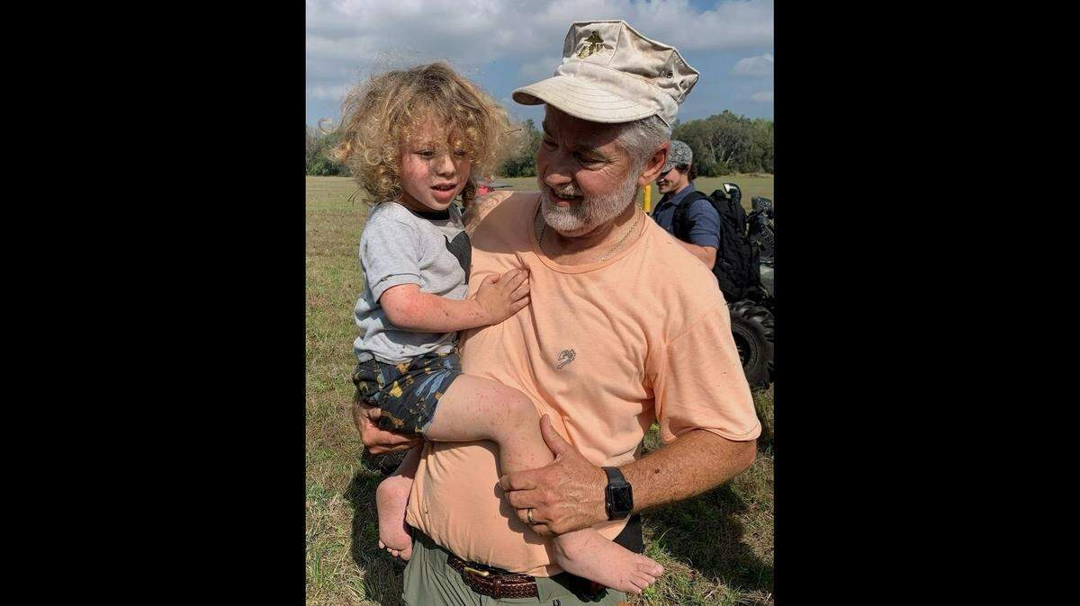 A toddler went missing from his Florida home as his parent slept. A former Marine found him in the woods, officials say.
