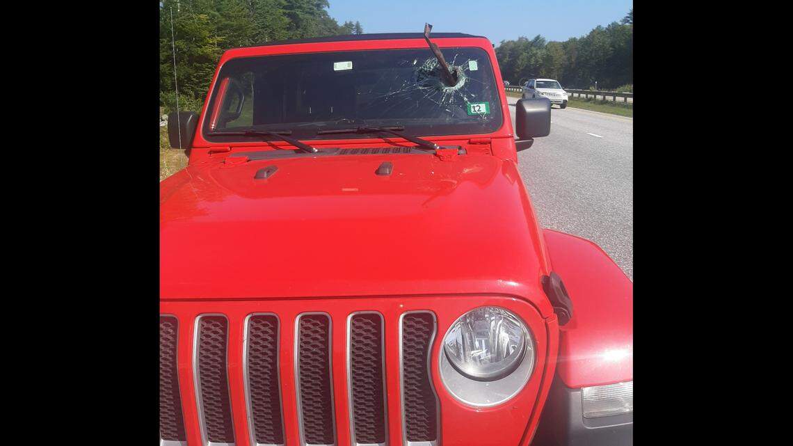 Metal road debris went through a New Hampshire driver’s windshield in Maine, according to police.