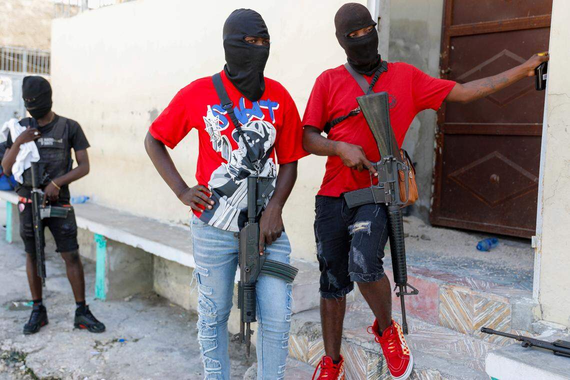 Masked members of “G9 and Family” gang stand guard during a press conference by their leader, Jimmy Cherizier, in Port-au-Prince, Haiti, Tuesday, March 5, 2024.